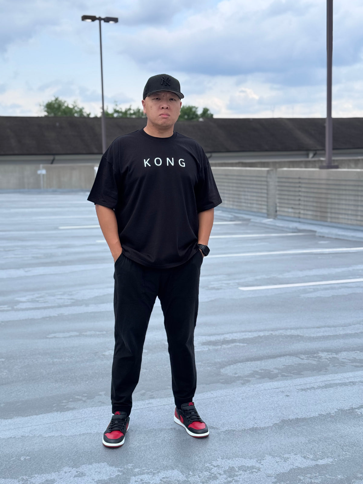 Model wearing the KONG Origin Tee on a rooftop, front view
